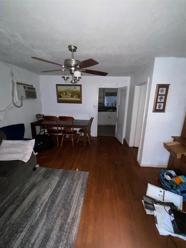 dining area featuring ceiling fan, dark hardwood / wood-style flooring, a textured ceiling, and a wall unit AC