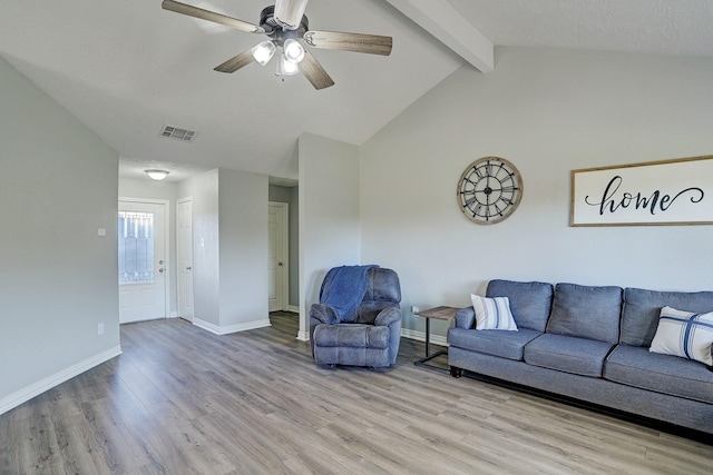 living room featuring vaulted ceiling with beams, ceiling fan, and light hardwood / wood-style flooring