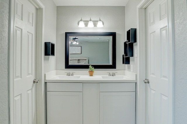 bathroom featuring ceiling fan and vanity