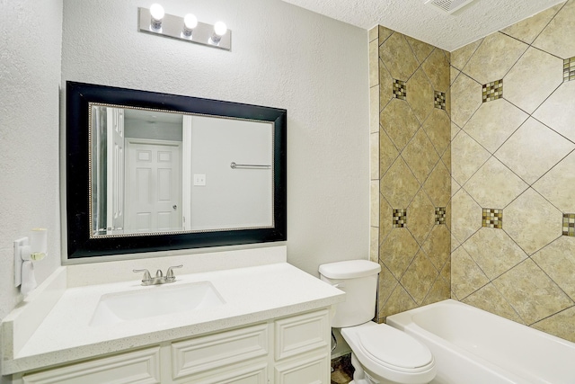 full bathroom with tiled shower / bath, vanity, a textured ceiling, and toilet