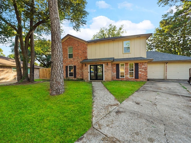 front of property with french doors, a front yard, and a garage