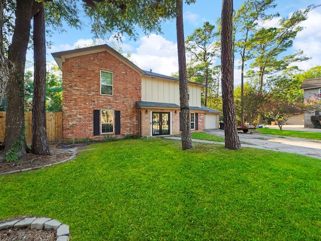 view of property with a front yard and a garage