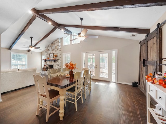 dining area with hardwood / wood-style flooring, ceiling fan, a barn door, and beam ceiling