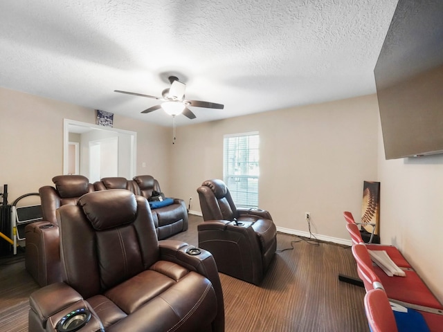 cinema featuring ceiling fan, hardwood / wood-style floors, and a textured ceiling