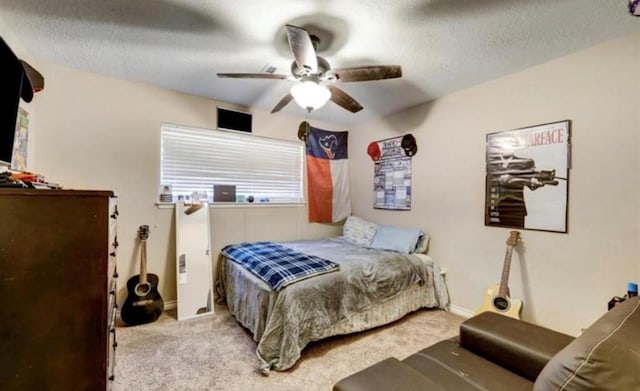 bedroom featuring light carpet, a textured ceiling, and ceiling fan