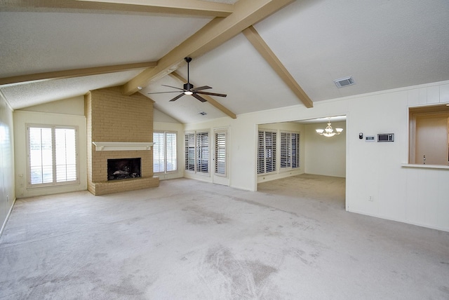 unfurnished living room with a brick fireplace, ceiling fan with notable chandelier, a textured ceiling, light colored carpet, and vaulted ceiling with beams