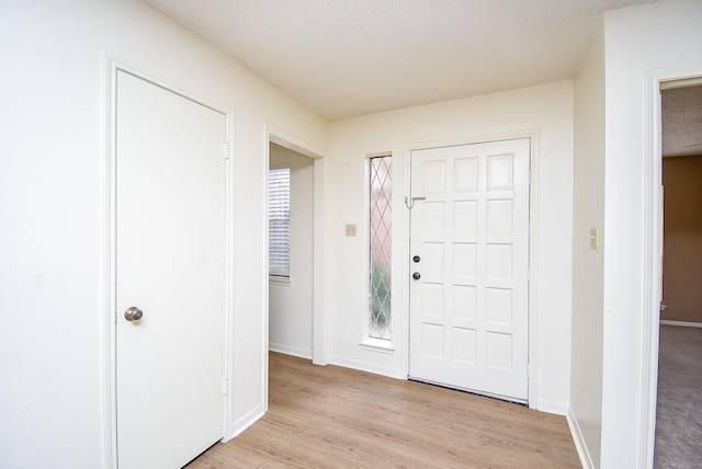 foyer with light hardwood / wood-style flooring and a textured ceiling