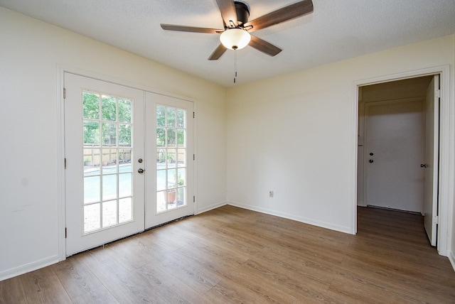 entryway featuring ceiling fan, wood-type flooring, a textured ceiling, and french doors