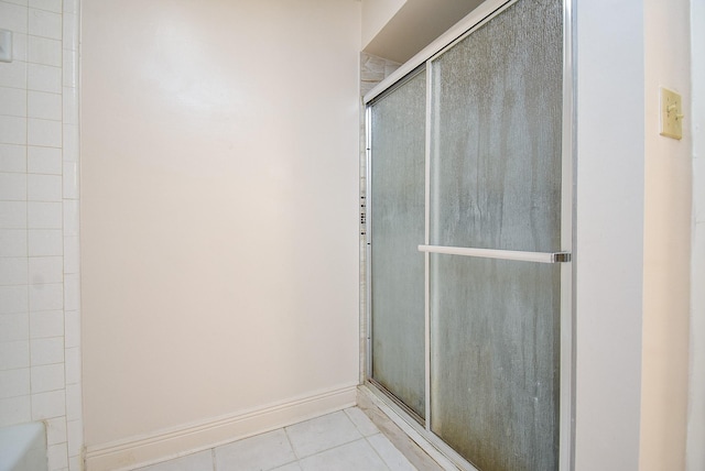 bathroom featuring tile patterned flooring and a shower with shower door