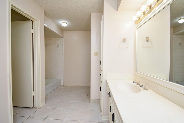 bathroom with vanity, a textured ceiling, and tile patterned floors