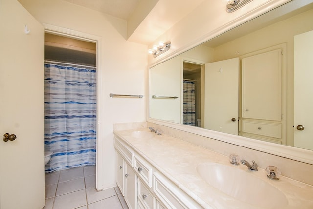 bathroom featuring tile patterned floors, vanity, and walk in shower