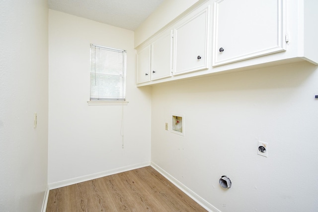 laundry room featuring cabinets, washer hookup, a textured ceiling, electric dryer hookup, and light hardwood / wood-style flooring