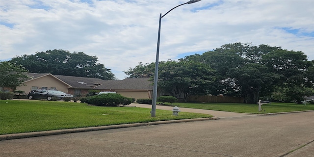 view of front facade featuring a garage and a front lawn