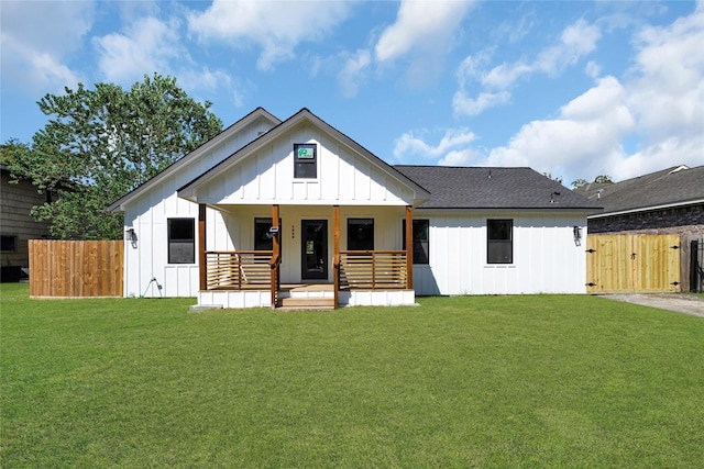 modern inspired farmhouse with a front yard and a porch