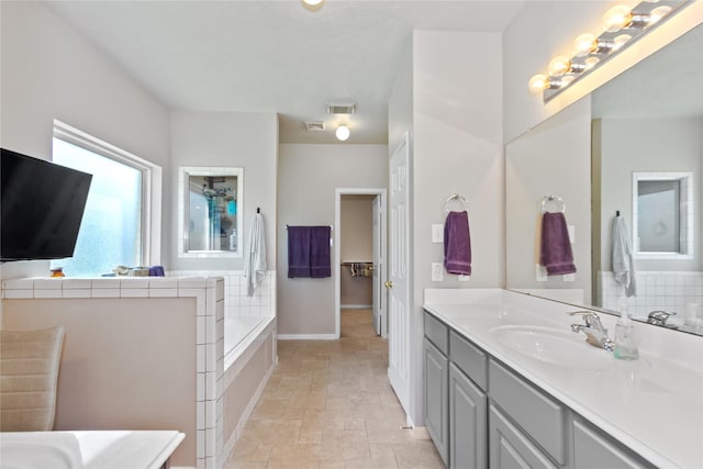 bathroom with vanity and a tub