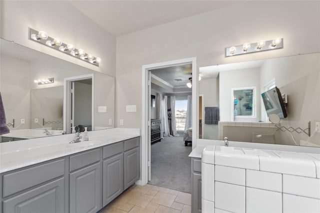 bathroom with crown molding, tile patterned flooring, and vanity