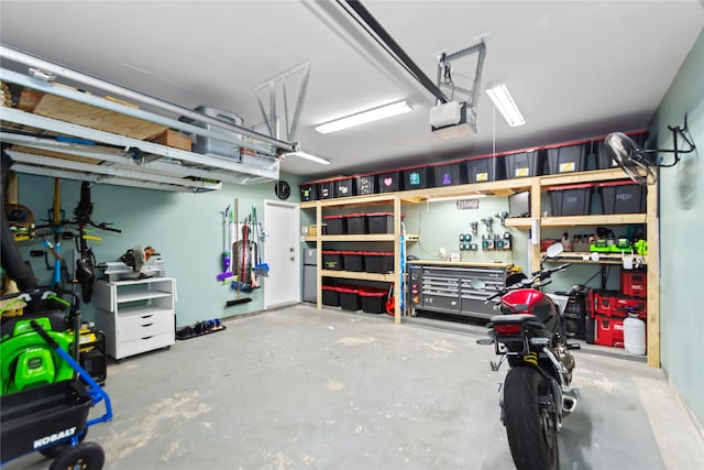 garage with a workshop area and a garage door opener