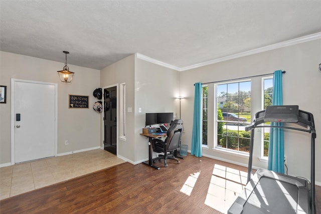 home office with ornamental molding and hardwood / wood-style flooring