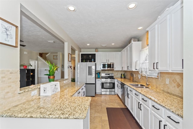 kitchen featuring white cabinets, stainless steel appliances, and sink