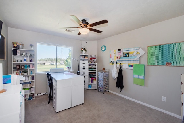 clothes washing area featuring ceiling fan and light carpet