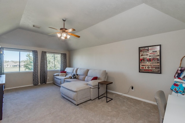 carpeted living room with ceiling fan and lofted ceiling