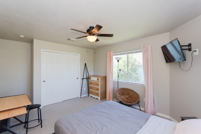 carpeted bedroom with a closet and ceiling fan