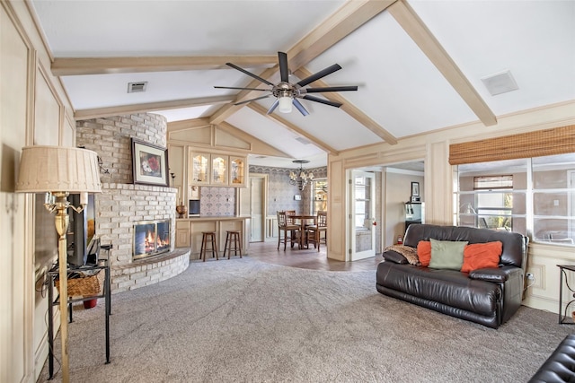 living room featuring a fireplace, vaulted ceiling with beams, dark carpet, and ceiling fan