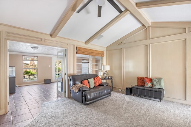 carpeted living room featuring vaulted ceiling with beams and ceiling fan