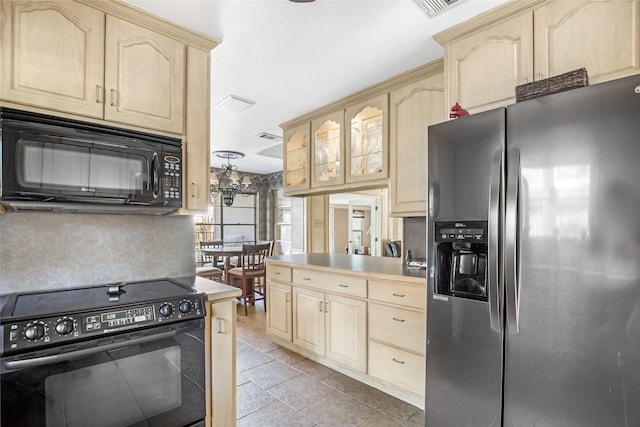 kitchen with a chandelier, light brown cabinets, and black appliances