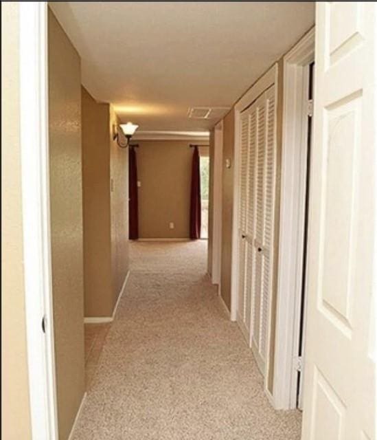 corridor with light colored carpet