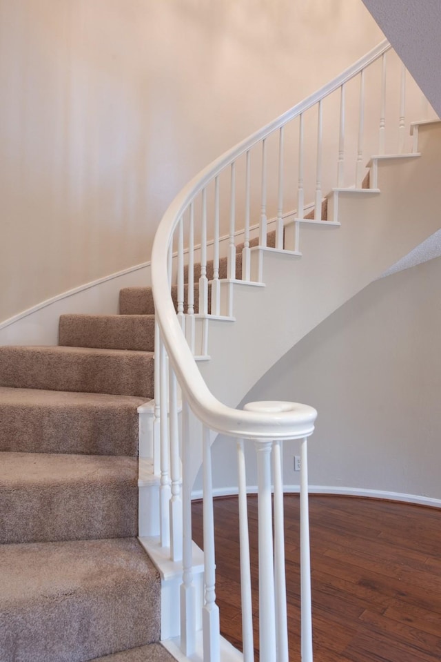 stairs featuring wood-type flooring