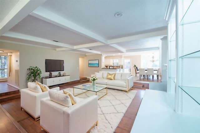 living room with beam ceiling, light wood-type flooring, a wealth of natural light, and coffered ceiling