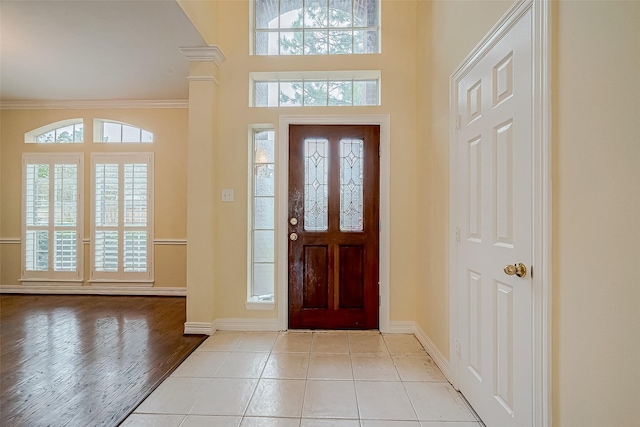 entryway featuring crown molding and light hardwood / wood-style floors