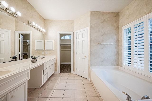 bathroom featuring a bath, vanity, and tile patterned floors