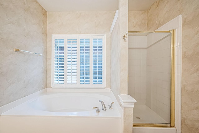 bathroom featuring independent shower and bath