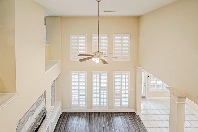 unfurnished living room featuring hardwood / wood-style floors, plenty of natural light, and ceiling fan