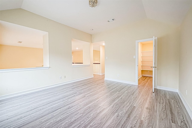 interior space with vaulted ceiling and light wood-type flooring