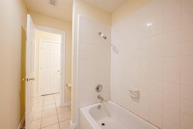 bathroom featuring tile patterned floors and tiled shower / bath