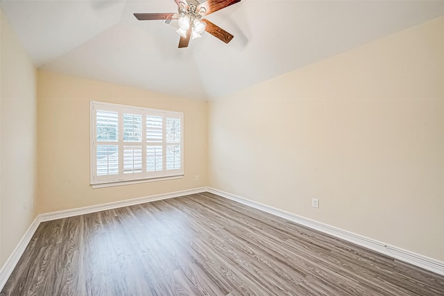 empty room featuring hardwood / wood-style floors, ceiling fan, and vaulted ceiling