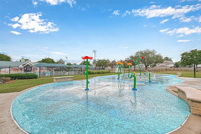 view of property's community with a playground and a lawn