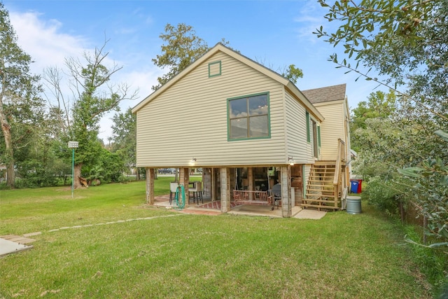 626 Clear Lake Rd, Clear Lake Shores, TX 77565 - back of house featuring a patio area, a yard, roof with shingles, and stairway