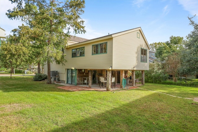 back of property with a yard, a patio, and central AC unit