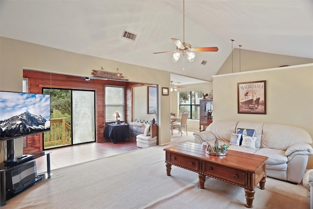 living room with ceiling fan, carpet, and high vaulted ceiling