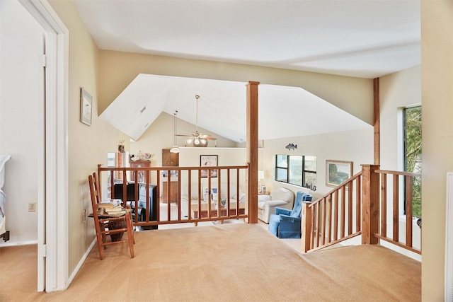 interior space featuring carpet, a wealth of natural light, and vaulted ceiling