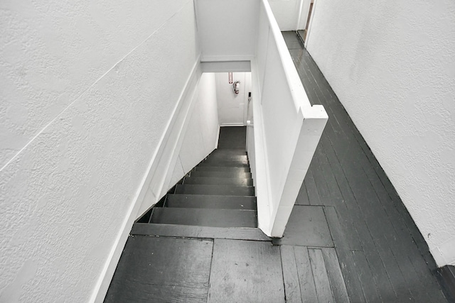 stairs featuring wood-type flooring