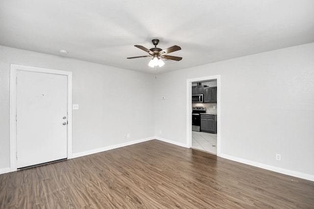 unfurnished room with hardwood / wood-style flooring and ceiling fan