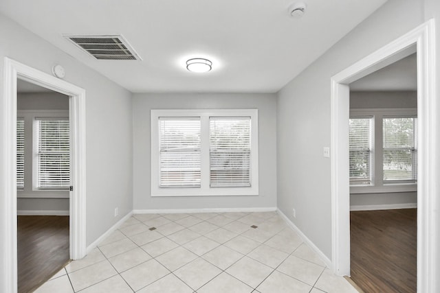 spare room with light hardwood / wood-style floors