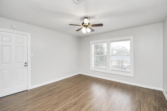 empty room featuring ceiling fan and dark hardwood / wood-style flooring