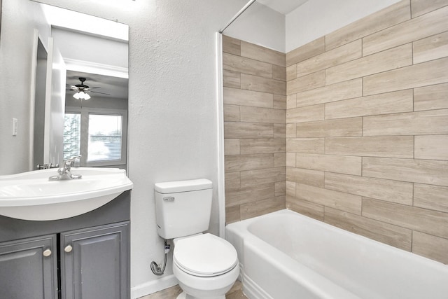 full bathroom with tiled shower / bath, vanity, toilet, and ceiling fan