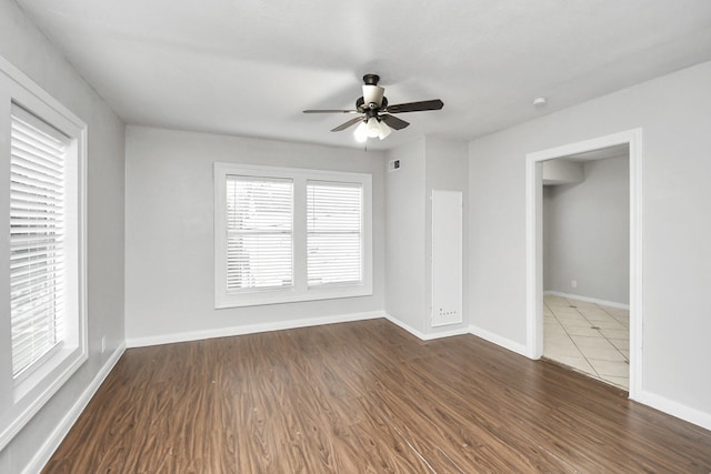 unfurnished room featuring ceiling fan and dark wood-type flooring